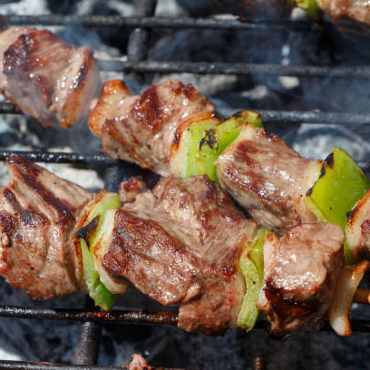 Beef brochette on the rack of a barbecue