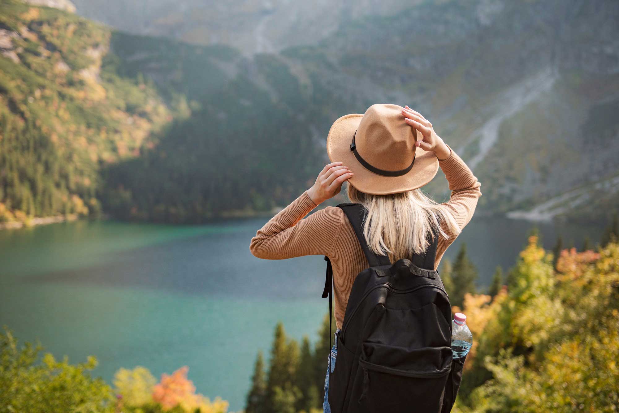 Woman traveling looking at a lake